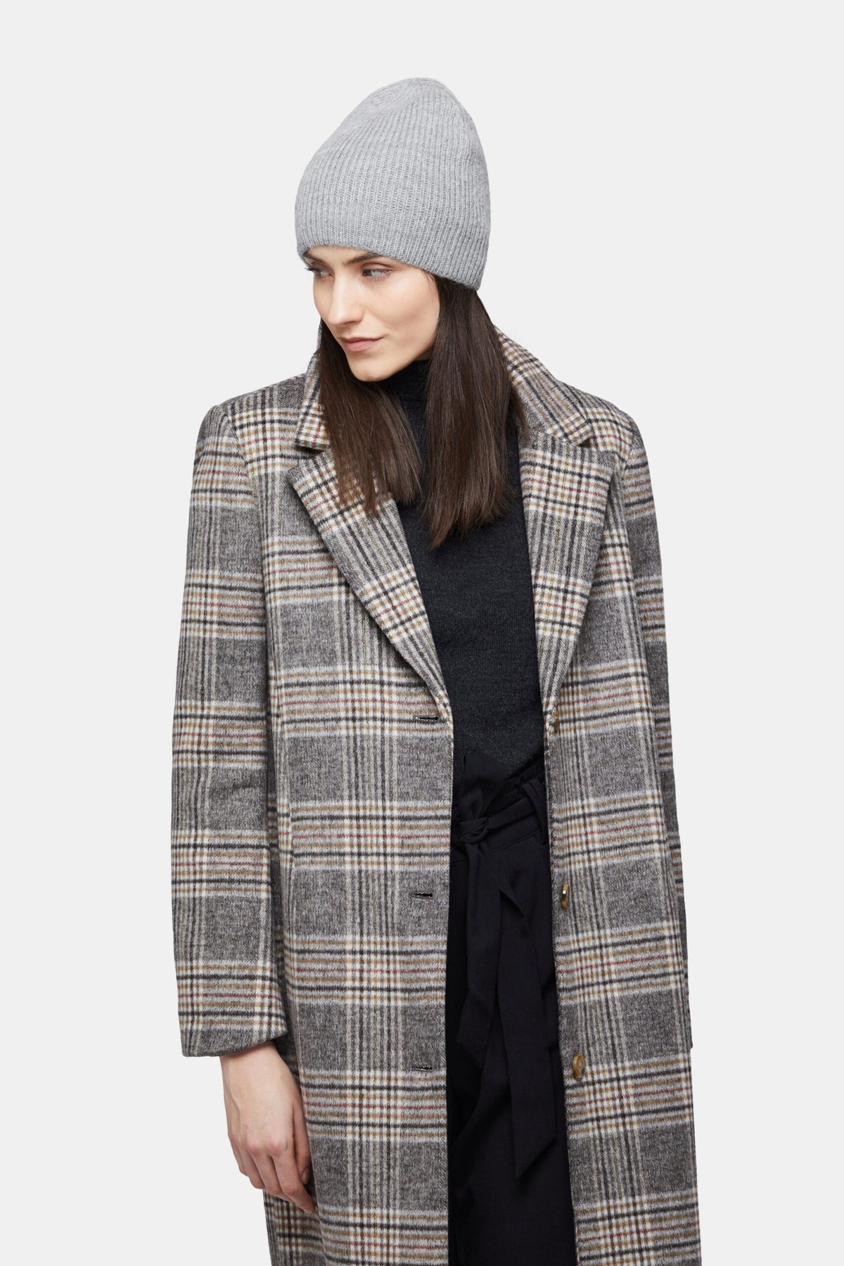 5. Woman wearing silver Alpaka baby alpaca wool fisherman's rib beanie with plaid coat, looking to the side