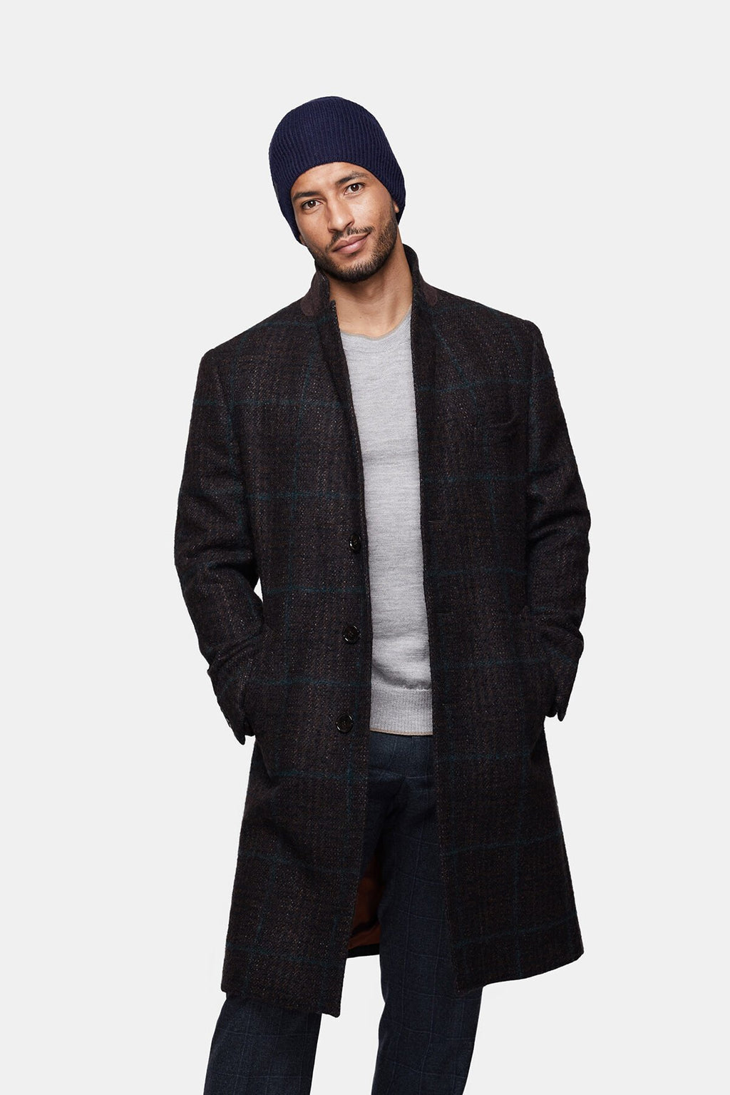 10. Man wearing navy Alpaka baby alpaca wool fisherman's rib beanie with dark coat, shown in front view