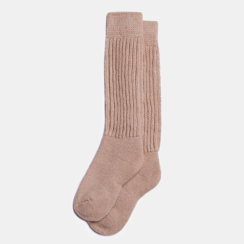 1. Unisex long alpaca wool socks in beige, featuring ribbed knit design, shown in studio setting