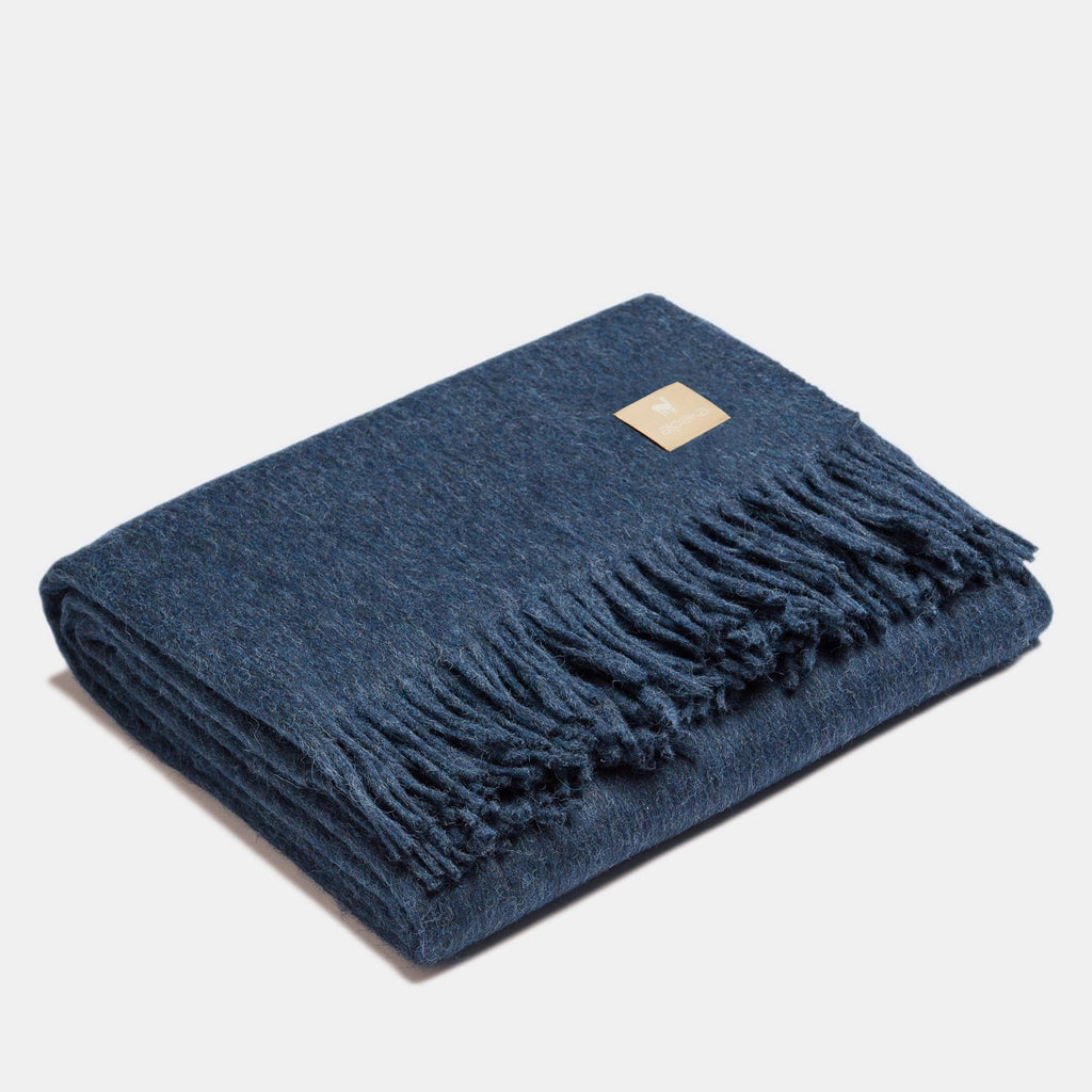 4. Navy Alpaka natural alpaca wool throw with fringe detail, folded in studio