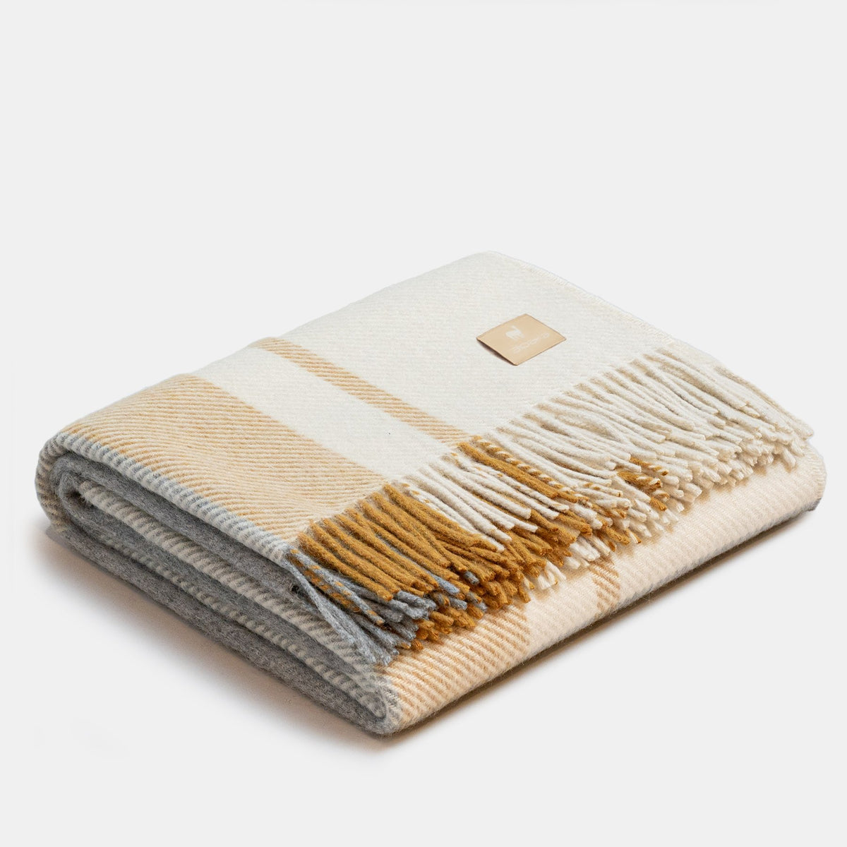 9. Folded Alpaka Natural Alpaca Wool Throw in Mustard/Silver, featuring fringe and design