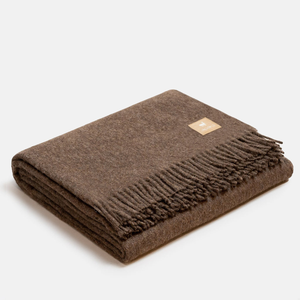 8. Dark camel Alpaka natural alpaca wool throw with fringe detail, folded in studio