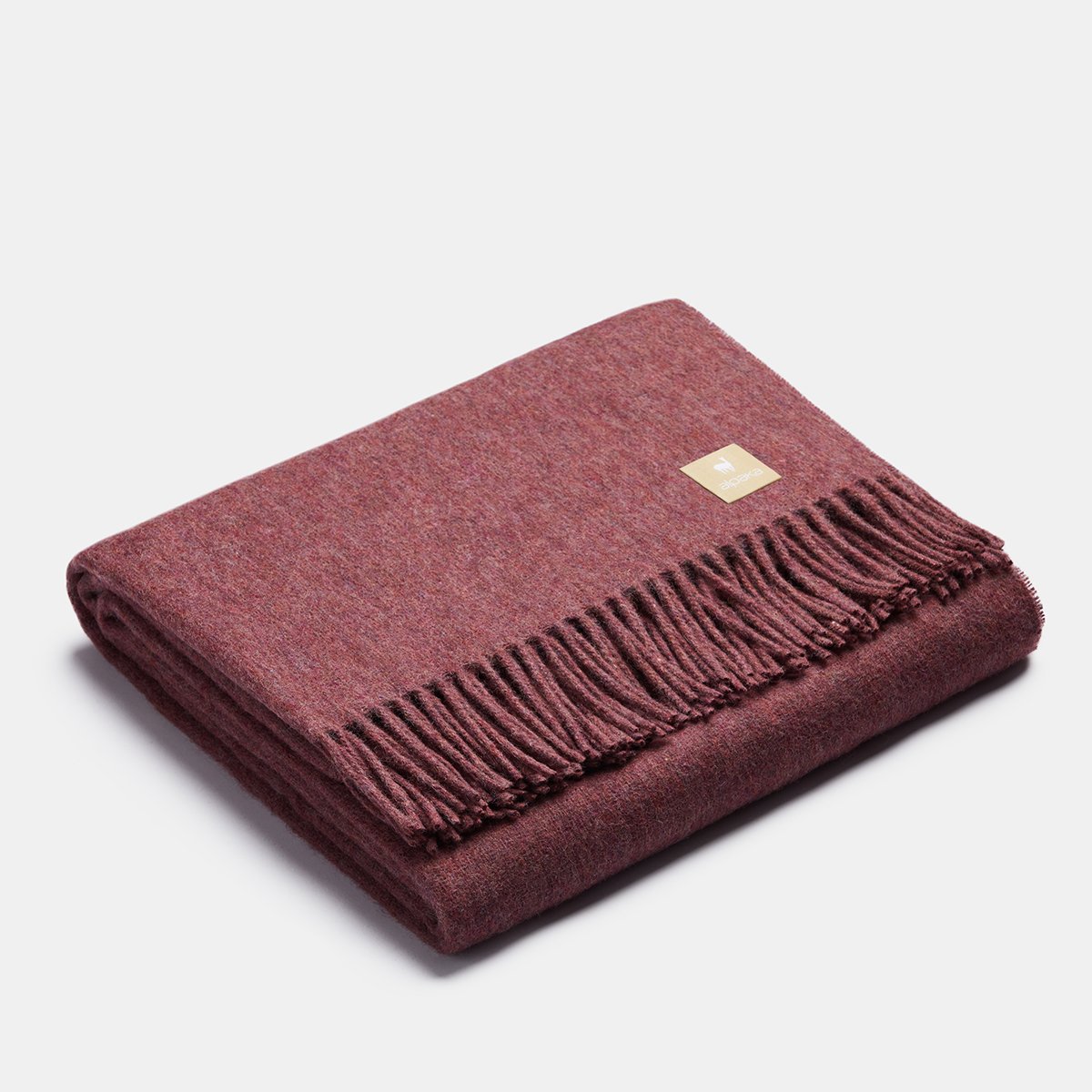 12. Steel blue Alpaka natural alpaca wool throw with fringe detail, folded in studio