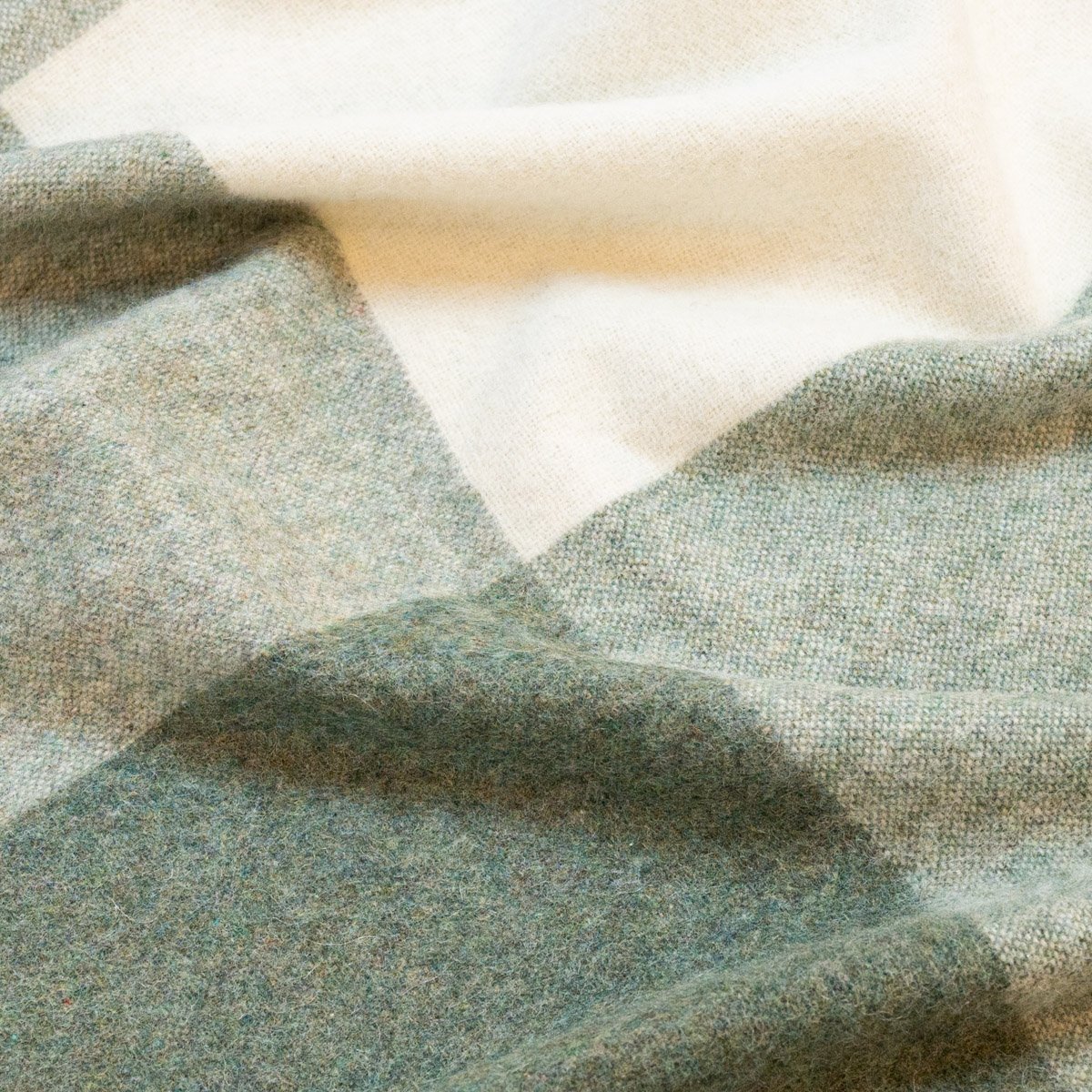 5. Close-up of green Recycled Alpaca Wool Throw showcasing the check pattern and soft texture