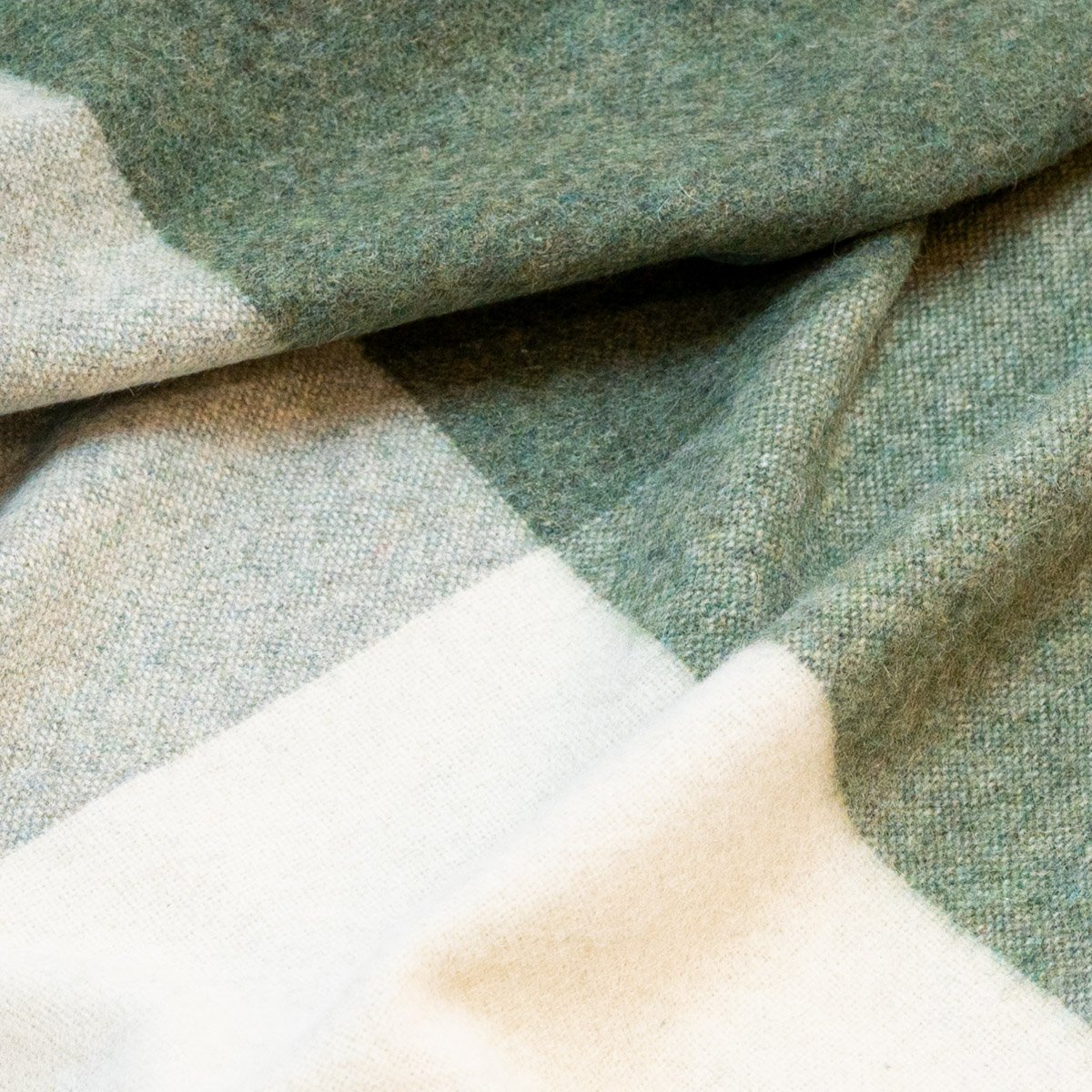 6. Detailed view of green Recycled Alpaca Wool Throw emphasizing the classic check design