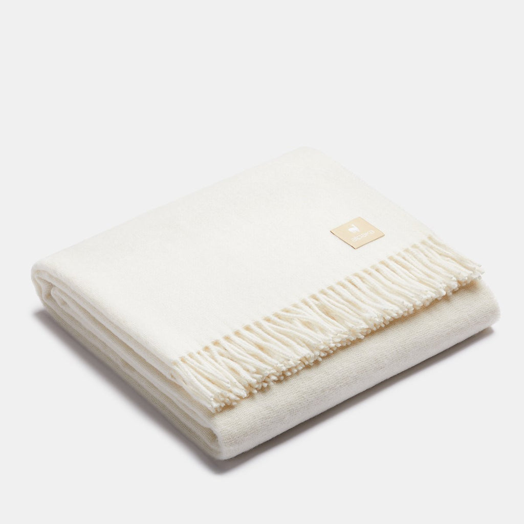 24. Light green Alpaka natural alpaca wool throw with fringe detail, folded in studio