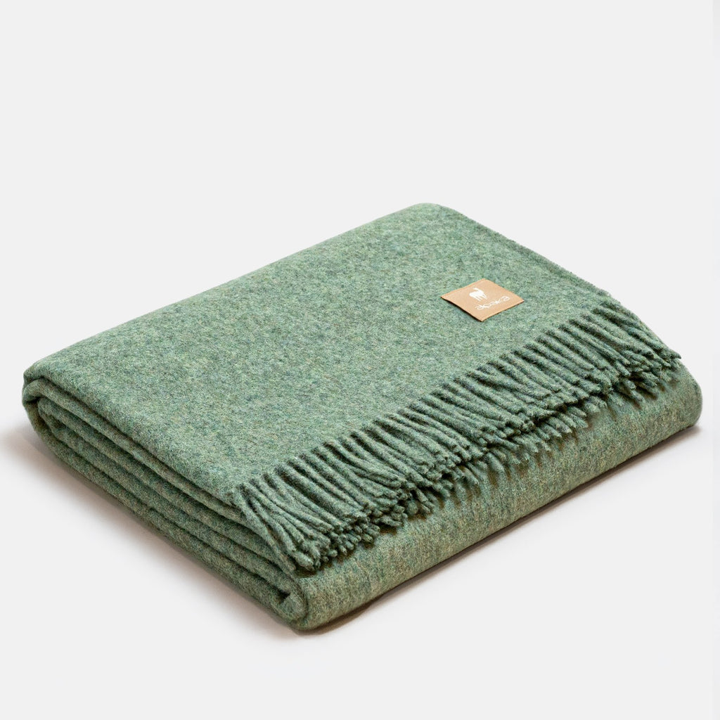 26. Rosé Alpaka natural alpaca wool throw with fringe detail, folded in studio