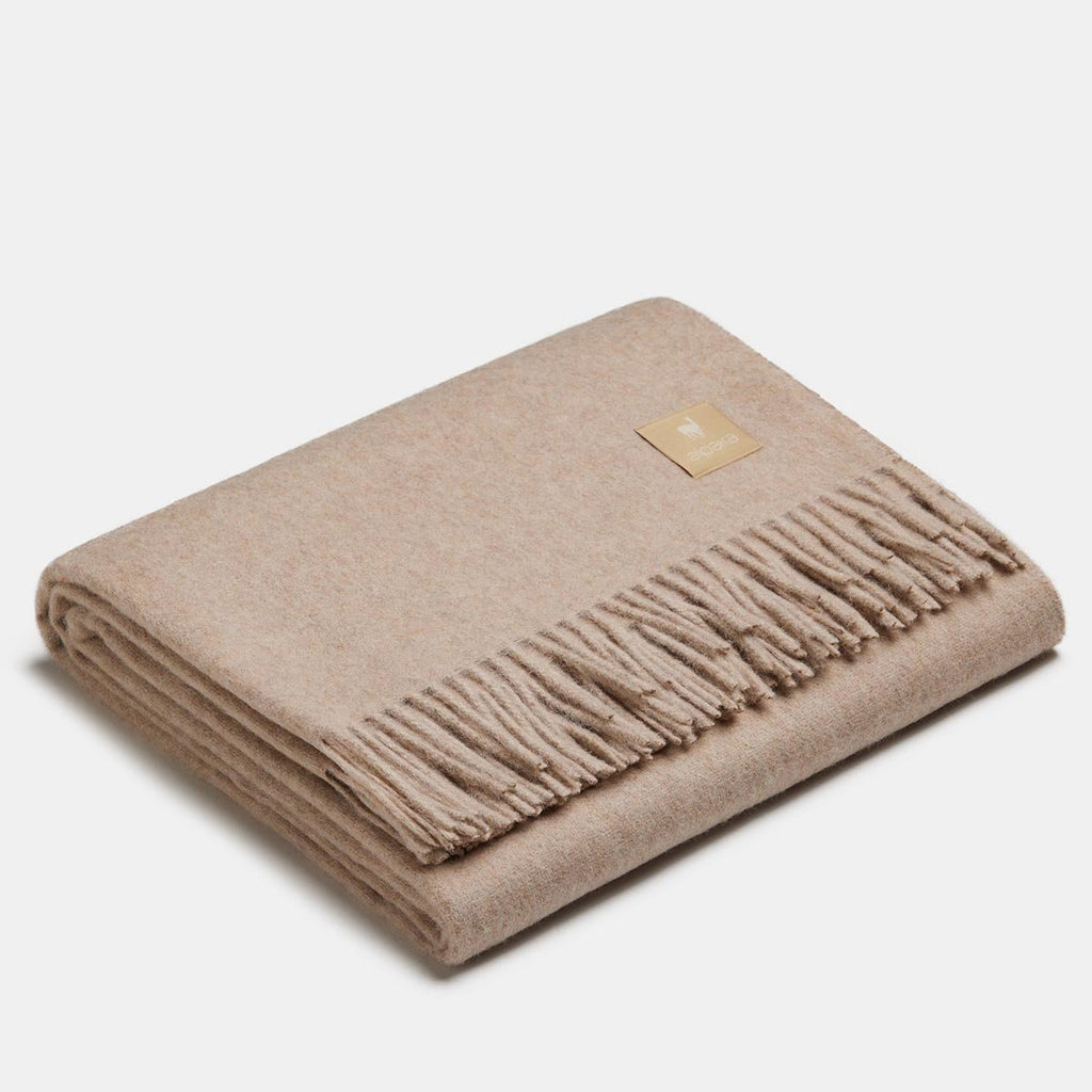 22. Ivory Alpaka natural alpaca wool throw with fringe detail, folded in studio