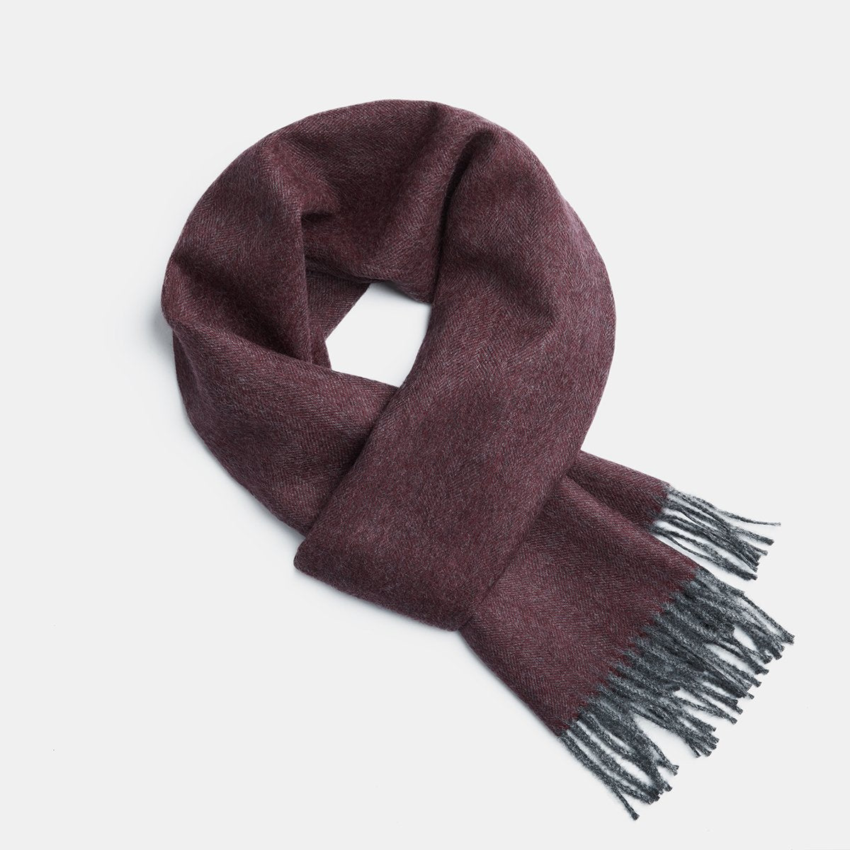 5. Studio image of Alpaka natural baby alpaca wool scarf in dark burgundy with fringe detail