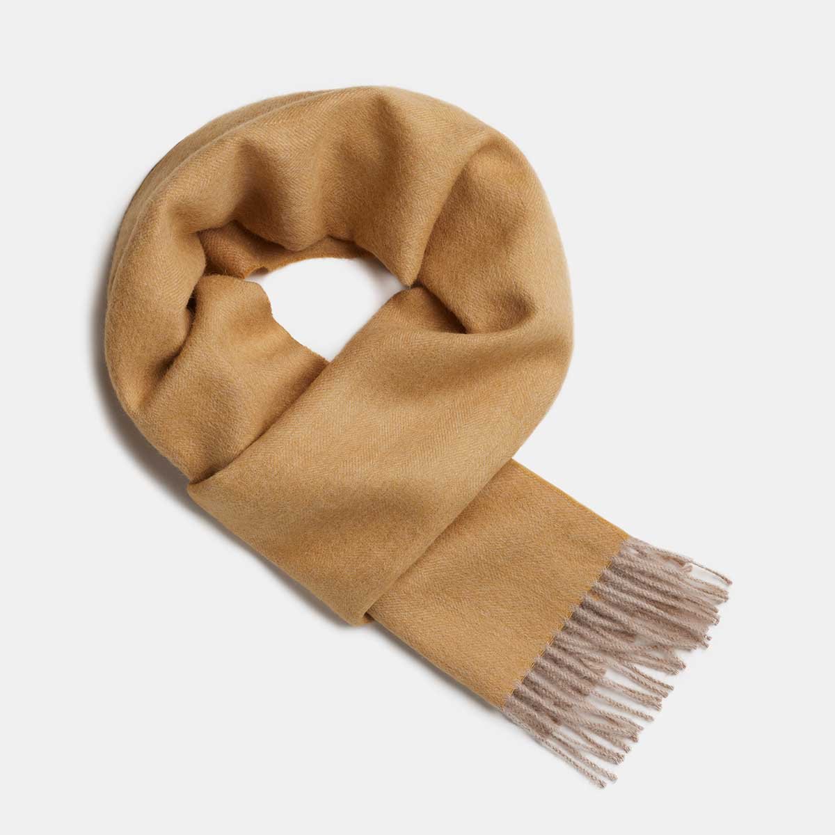 18. Studio image of Alpaka natural baby alpaca wool scarf in camel with fringe detail