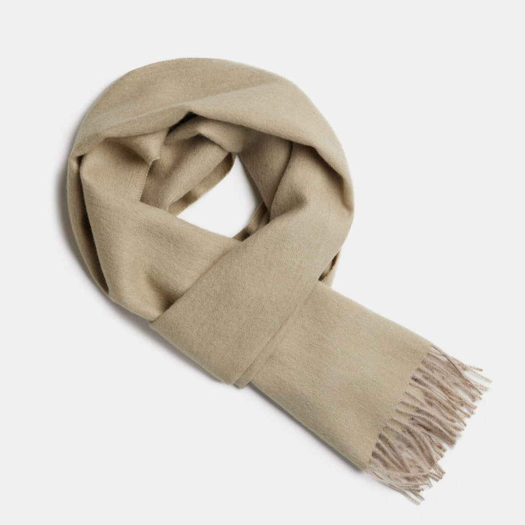 20. Studio image of Alpaka natural baby alpaca wool scarf in beige with fringe detail