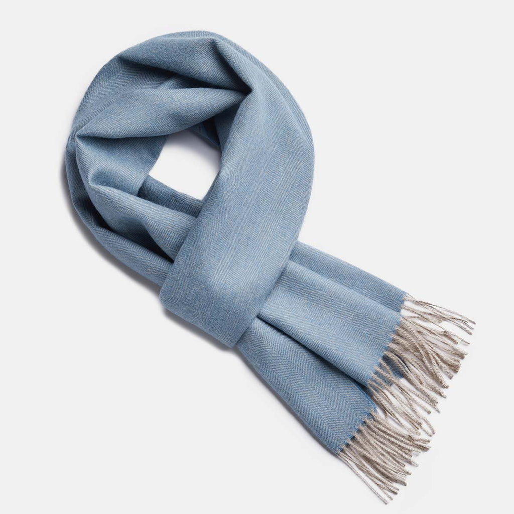 9. Studio image of Alpaka natural baby alpaca wool scarf in light blue with fringe detail