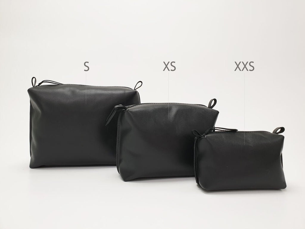 3. Studio shot of Zelma Kraft black leather cosmetic bags in sizes S, XS, and XXS