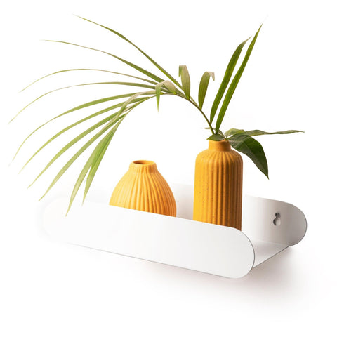 1. White floating wall shelf with two yellow vases and green plant, minimalist design by Ewart Woods