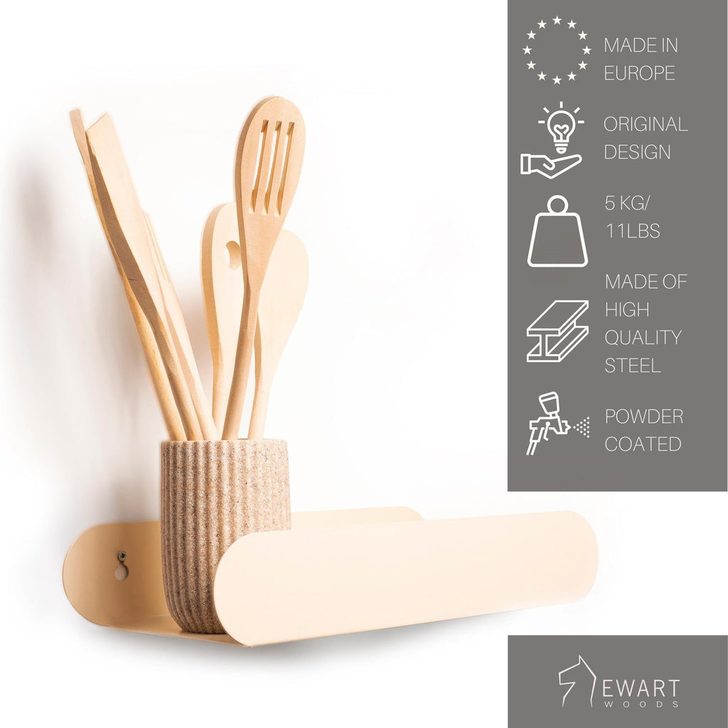 3. Beige floating wall shelf with wooden utensils in a ribbed vase, Ewart Woods branding
