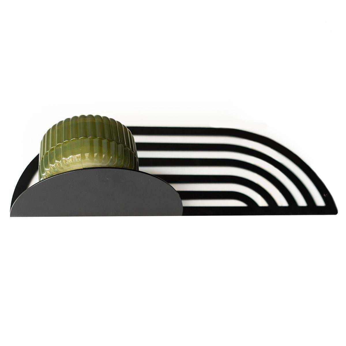 6. Black metal plant shelf with green pot, viewed from above to show design