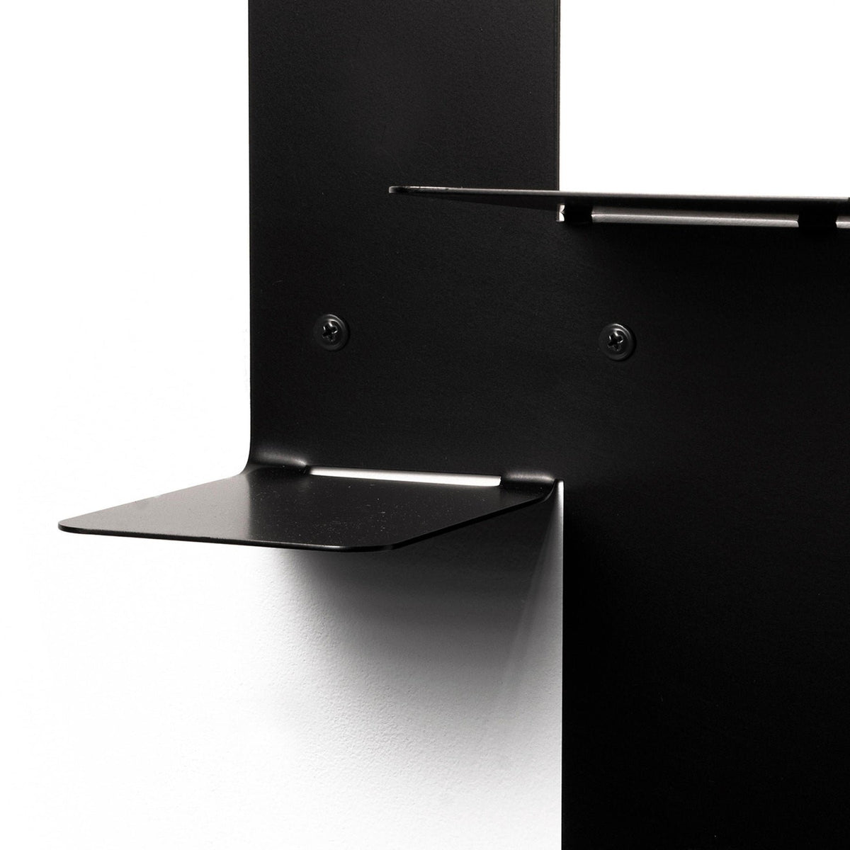 3. Close-up of black metal floating wall shelf showing mounting details