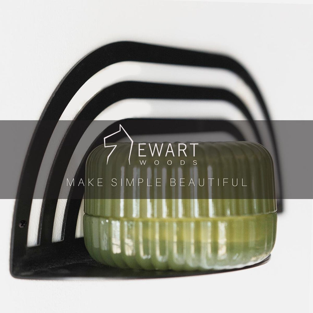 7. Black metal plant shelf with green pot, featuring Ewart Woods logo and slogan
