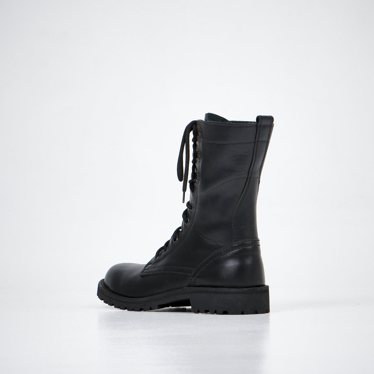1. Aipi black handmade leather boots with lace-up closure, side view in studio setting