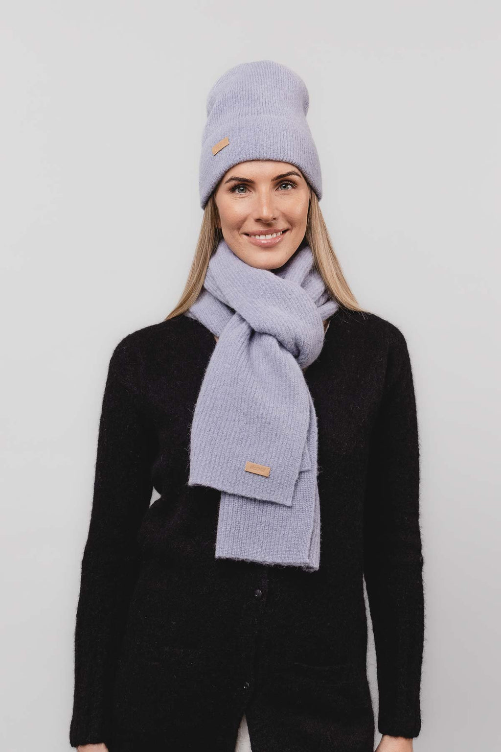 26. Women's dusty blue Alpaka Fisherman's Rib scarf and hat set in studio setting
