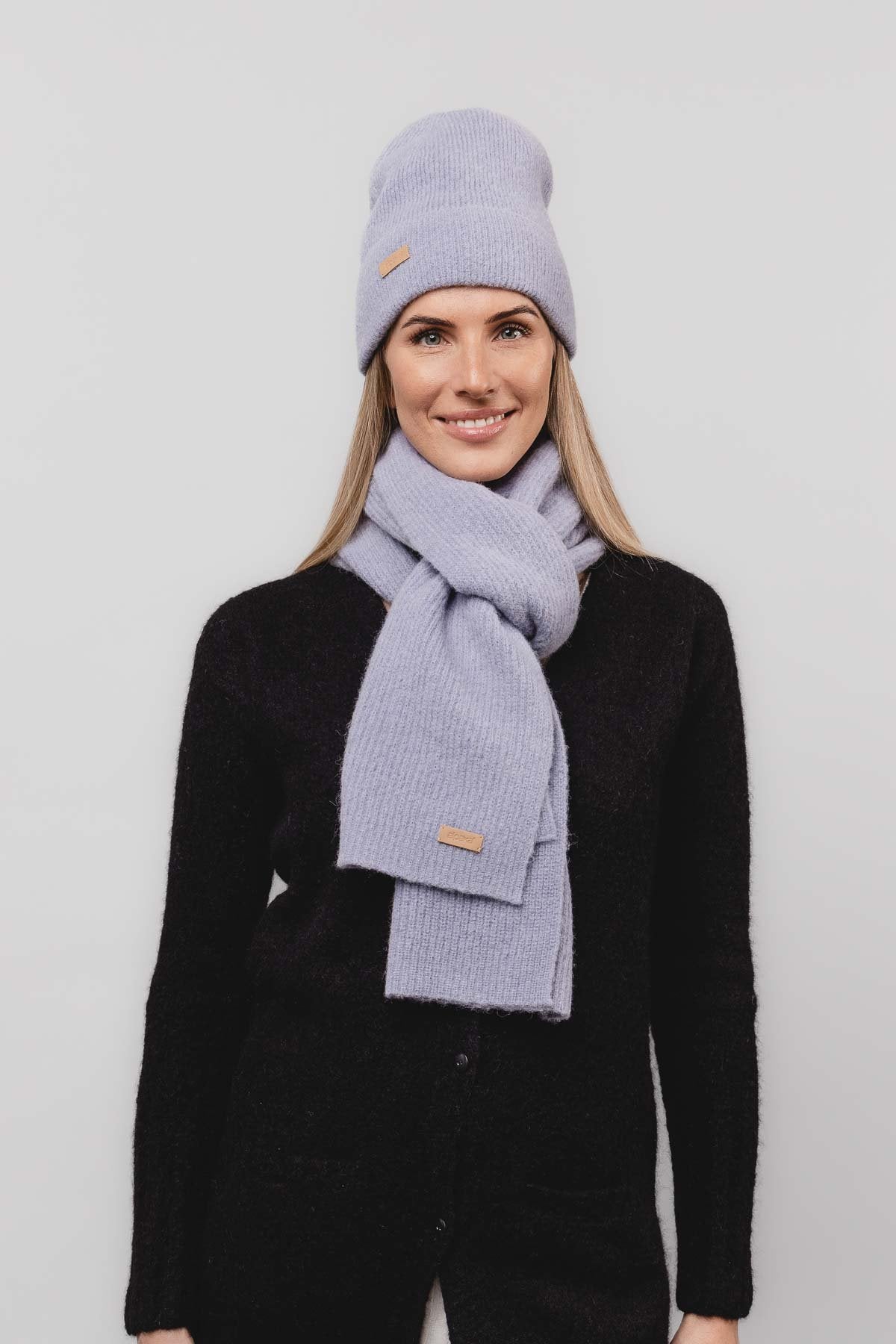 26. Women's dusty blue Alpaka Fisherman's Rib scarf and hat set in studio setting