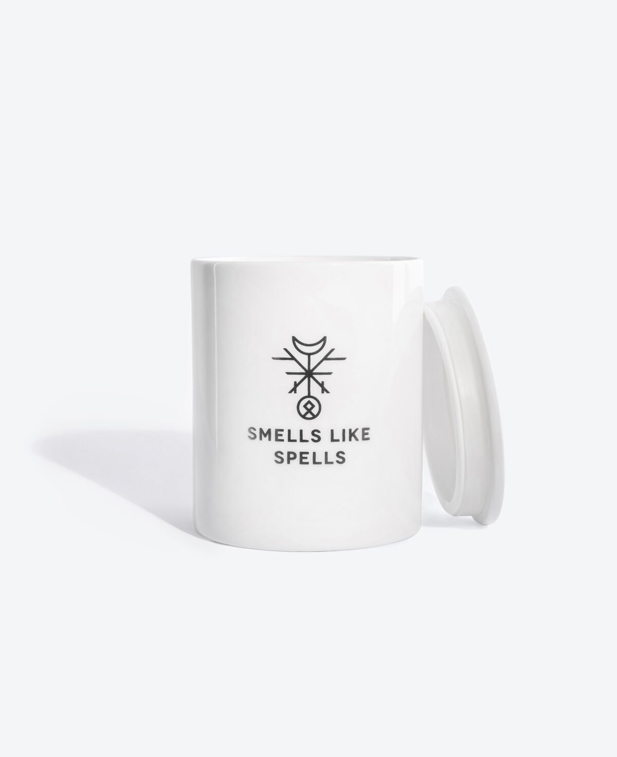 3. Smells Like Spells scented candle with lid, displayed in white porcelain container with logo