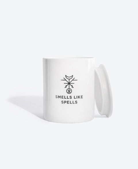 3. Smells Like Spells scented candle with lid, displayed in white porcelain container with logo