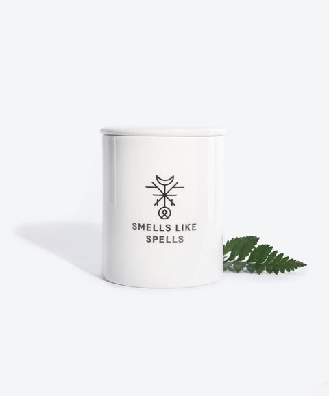 2. Smells Like Spells Scented Candle THE SUN with fern leaf, white porcelain container, studio setting