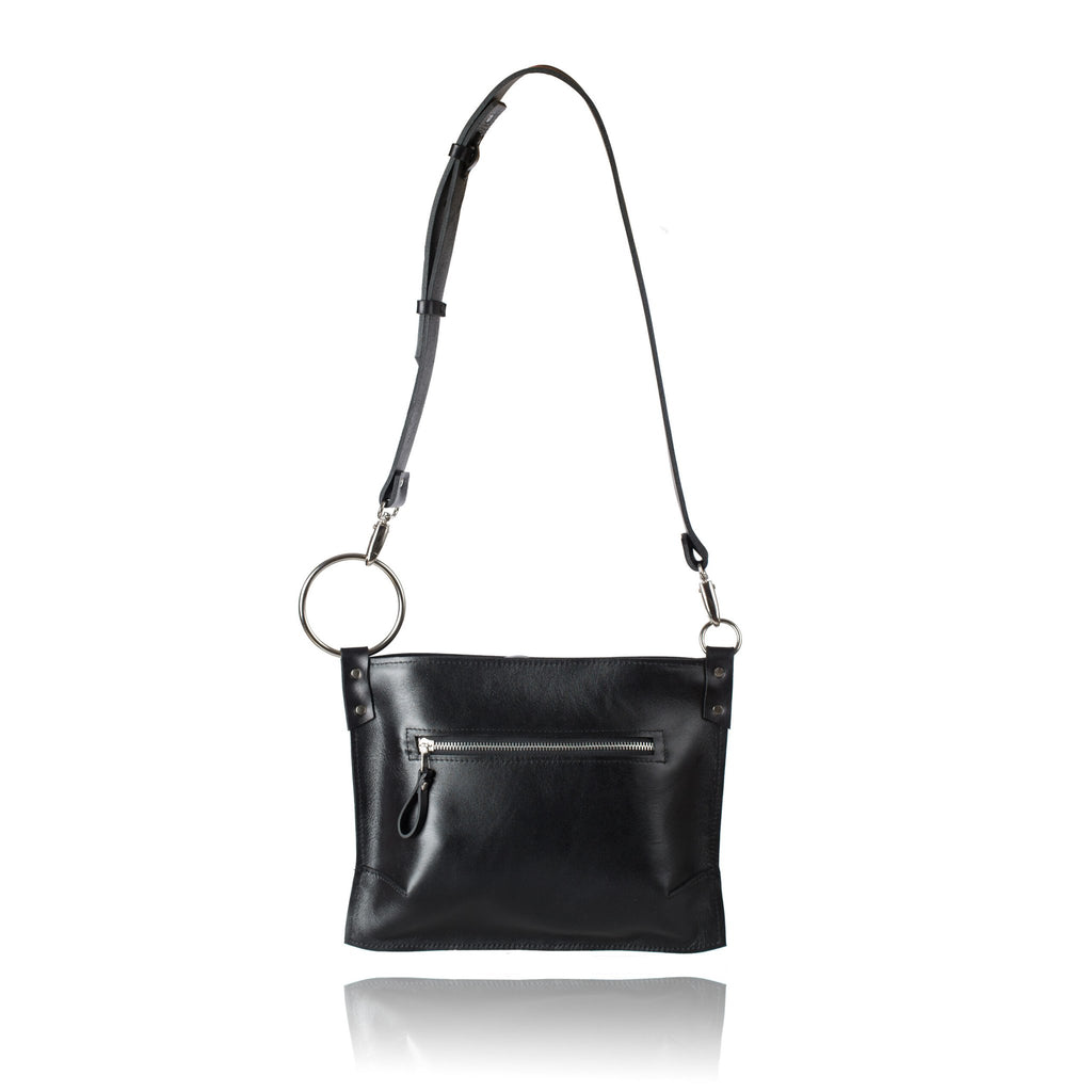 3. Studio image of PYKOK Serenity black leather handbag with adjustable strap and front zipper