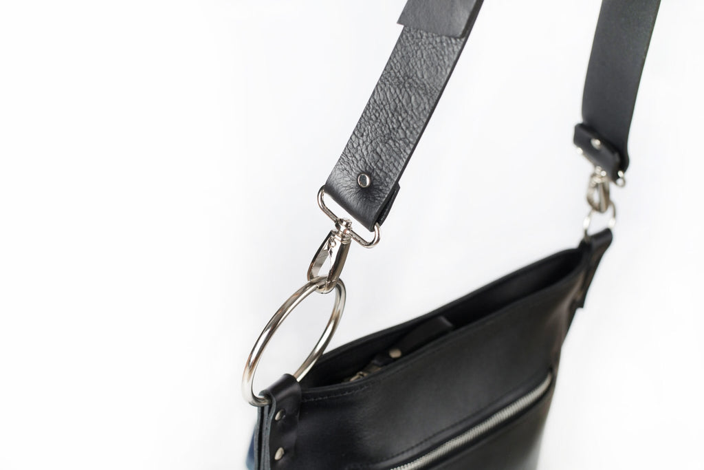 4. Close-up of PYKOK Serenity handbag's adjustable leather strap and metal ring detail