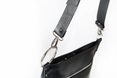 4. Close-up of PYKOK Serenity handbag's adjustable leather strap and metal ring detail