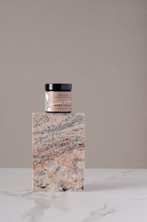 2. BONOBO Avocado and Lemon Body Cream jar on marble block, studio setting