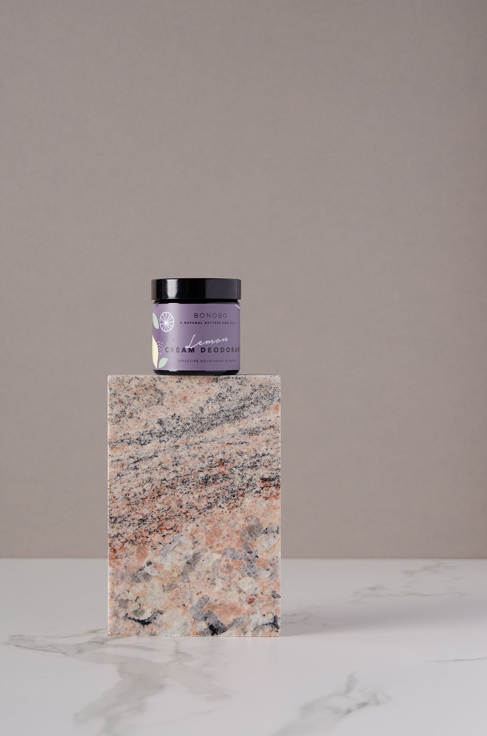 1. BONOBO Lemon Deodorant-Cream jar displayed on a marble block in a studio setting
