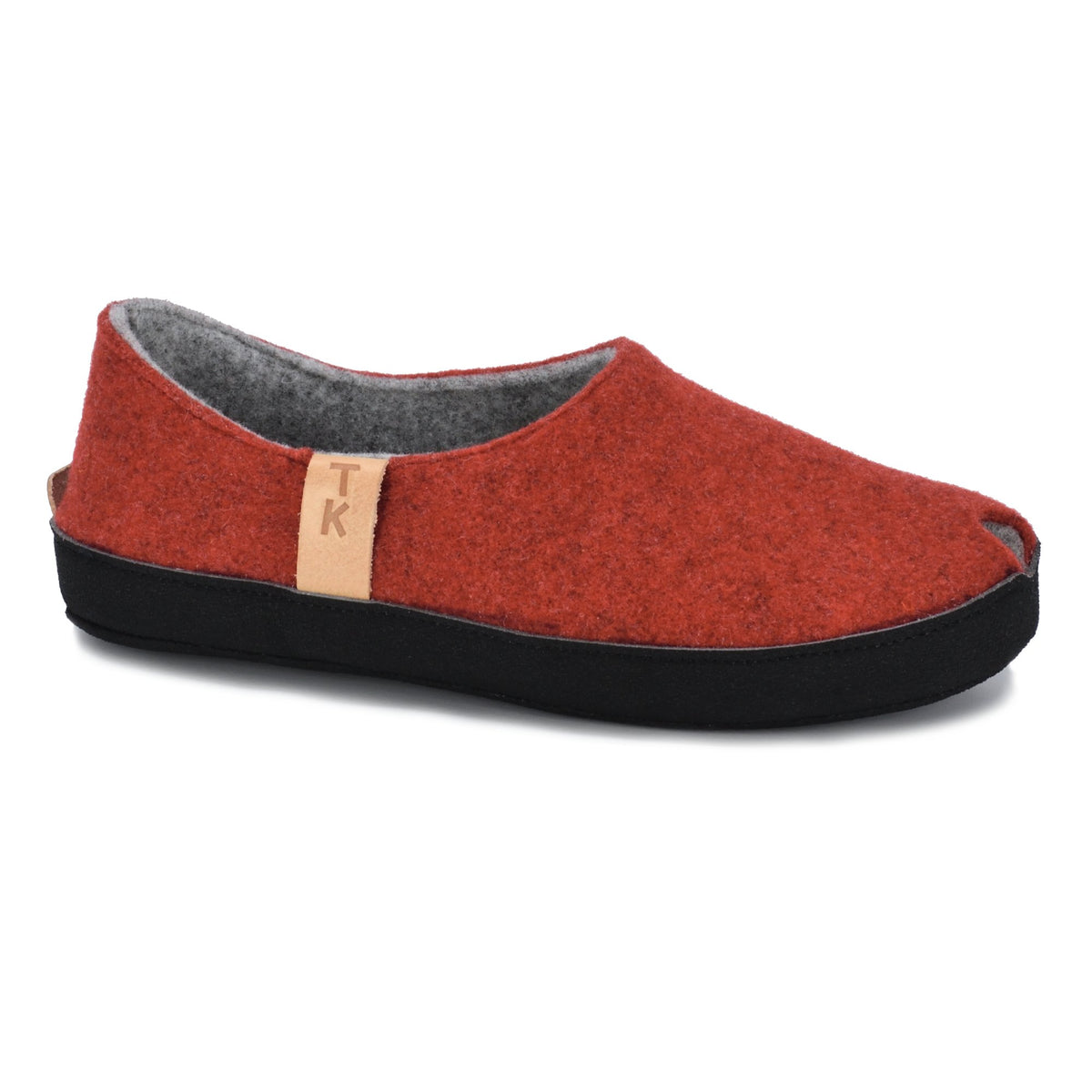 1. Omaking TOKU Budapest red slippers in studio, showcasing closed heel and toe design with natural lambswool felt