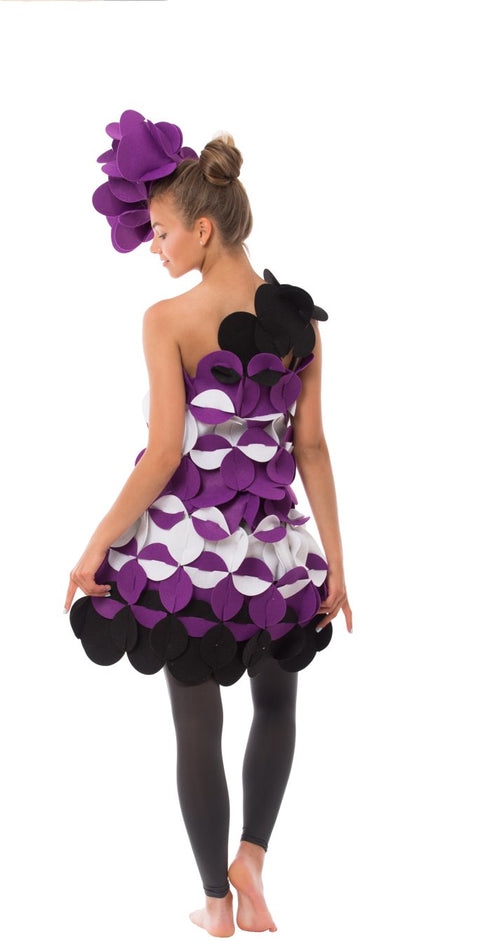 3. Woman in purple and black felt costume with floral headpiece shown from back on black background