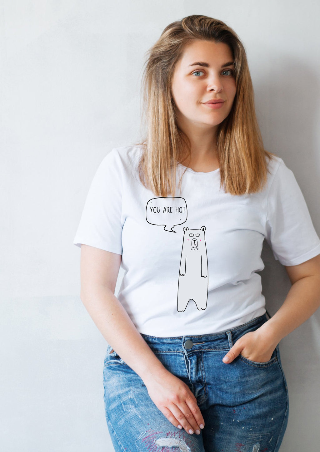 1. Women's white 'You Are Hot' T-shirt by Black Giraffe Brand, featuring a playful bear graphic, worn by a model in a casual setting