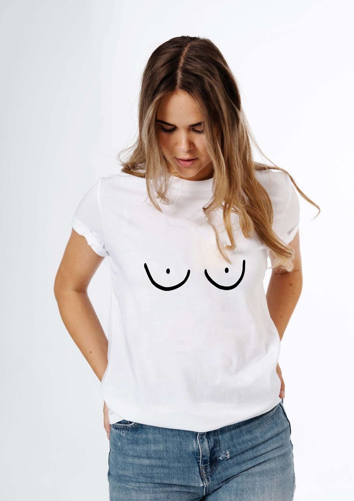 1. Women's Boobs T-Shirt in white by Black Giraffe Brand, worn by model with rolled-up sleeves, showcasing oversized fit