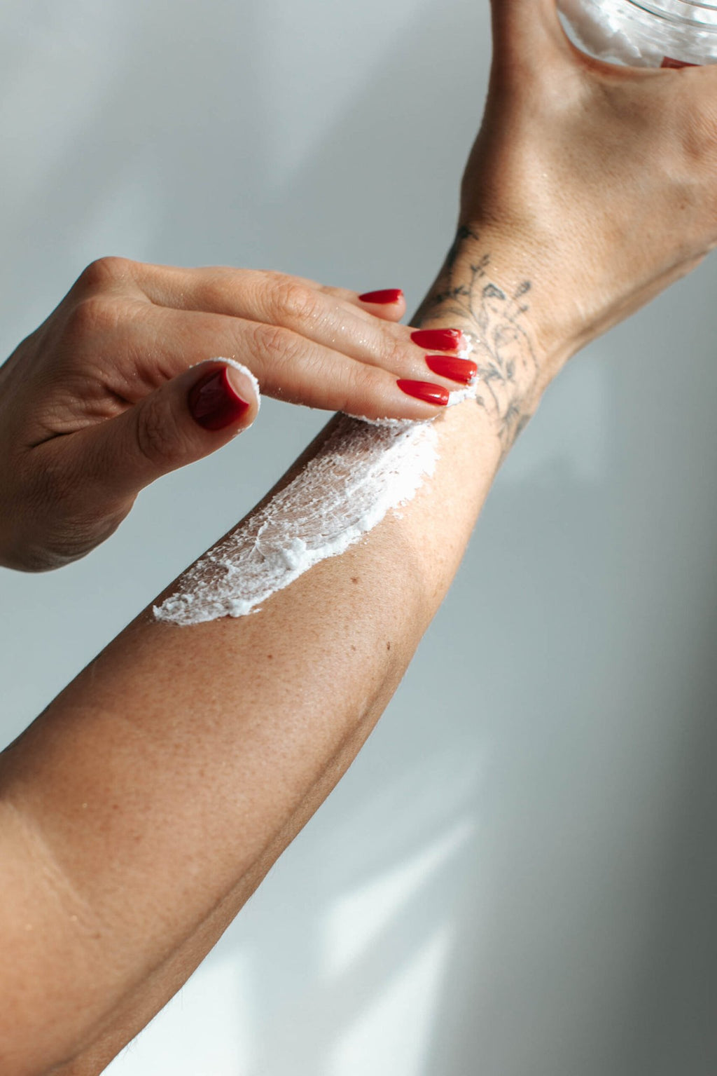 4. Application of Black Giraffe Brand Exfoliating Shower Cream on arm, showing creamy texture