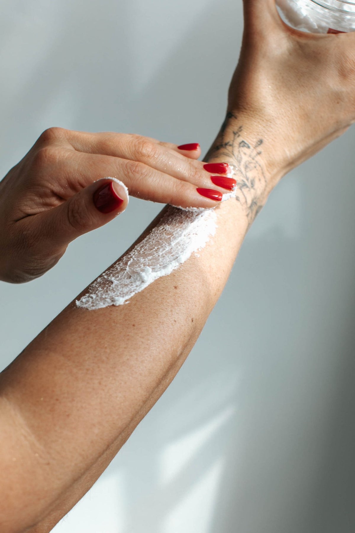 4. Application of Black Giraffe Brand Exfoliating Shower Cream on arm, showing creamy texture