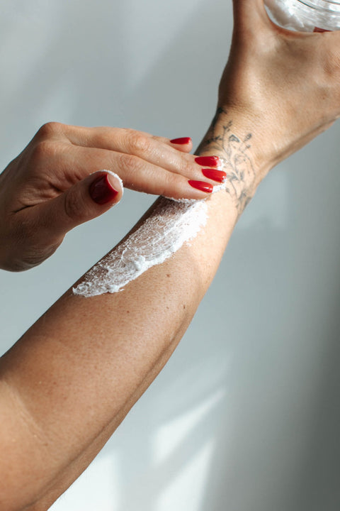 4. Application of Black Giraffe Brand Exfoliating Shower Cream on arm, showing creamy texture