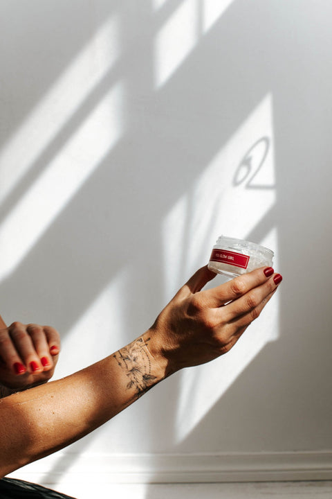 5. Woman holding Black Giraffe Brand Sparkling Body Gel jar, highlighting product label