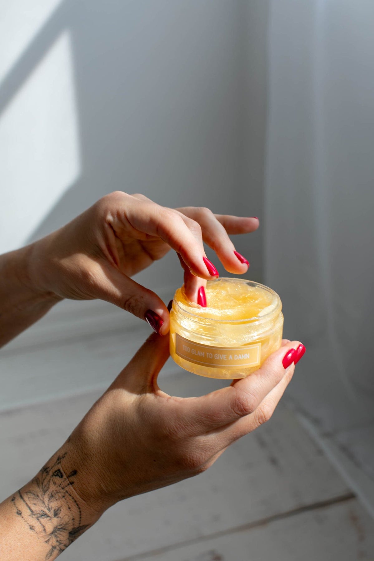 6. Close-up of hands holding Black Giraffe shower cream, showing texture and packaging