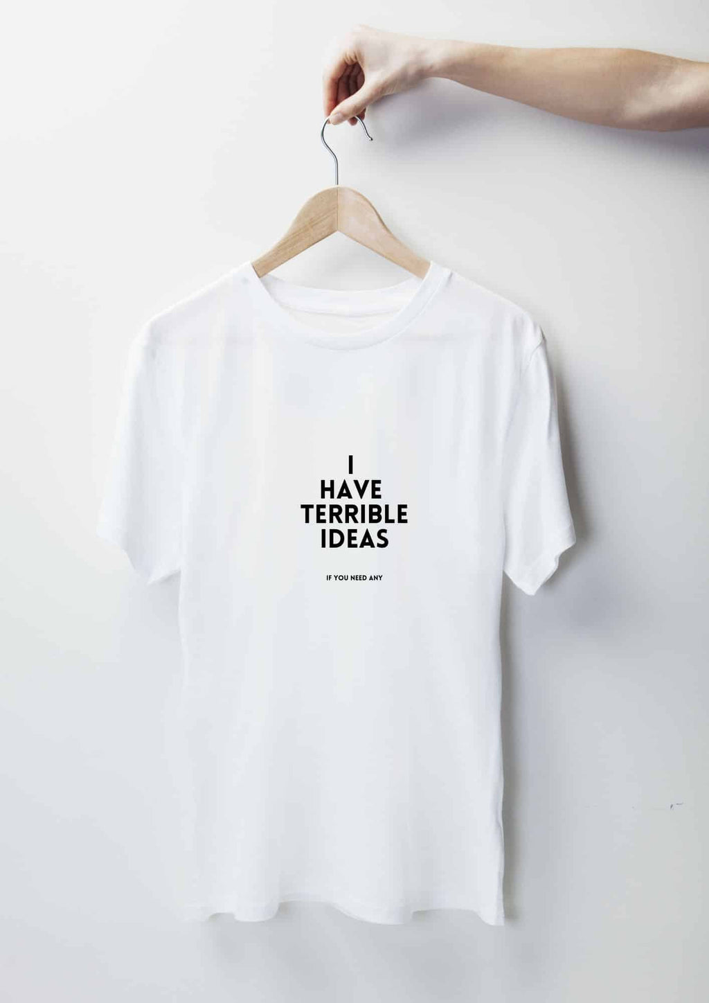 3. White 'I Have Terrible Ideas' t-shirt by Black Giraffe Brand, displayed on hanger in studio setting