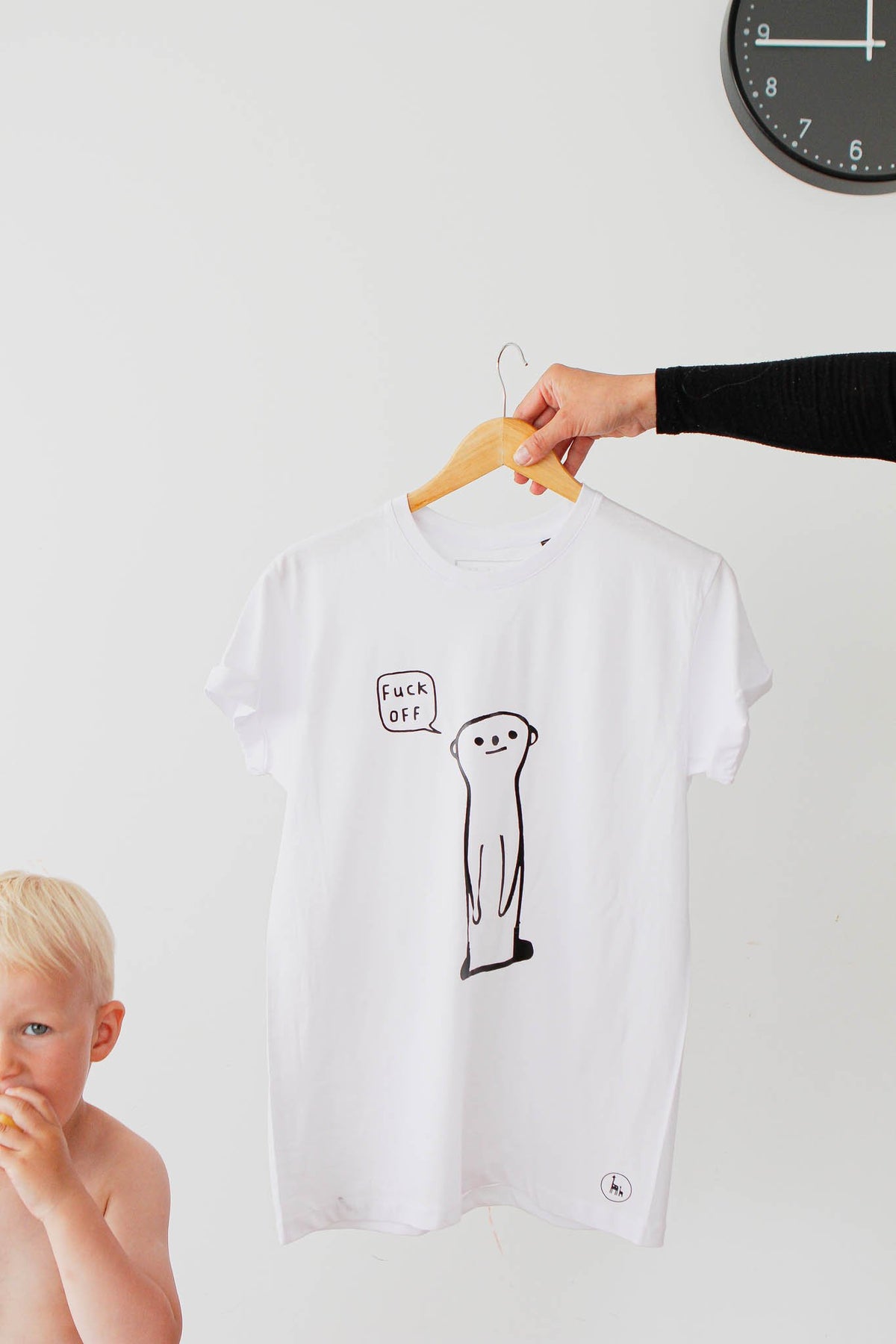 1. White oversized T-shirt with cheeky meerkat design and 'fuck off' text by Black Giraffe Brand, shown on hanger