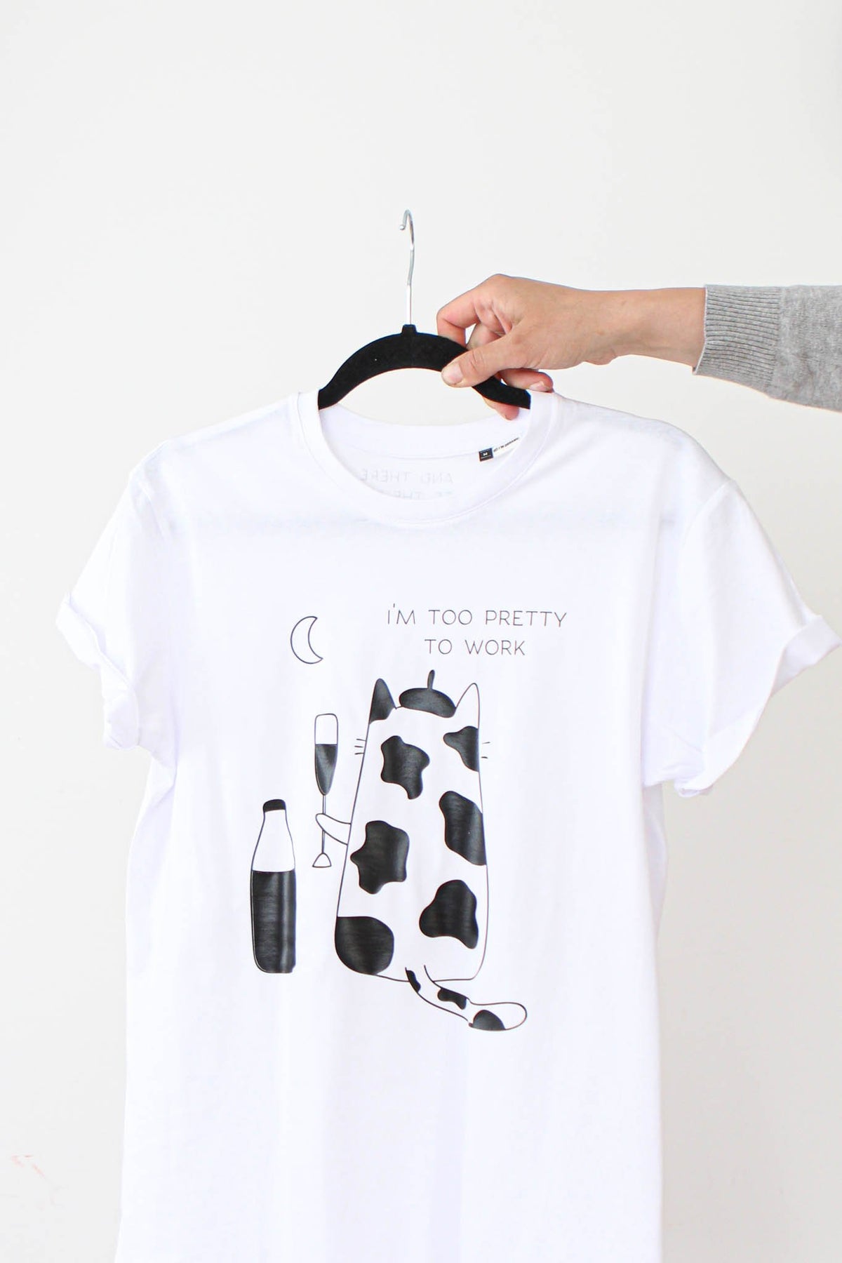 1. Women's oversized white T-shirt by Black Giraffe Brand with 'I'm Too Pretty to Work' print, shown on hanger