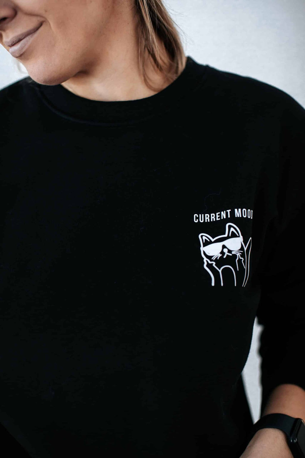 1. Women's oversized black sweatshirt with grumpy cat design by Black Giraffe Brand, worn by model