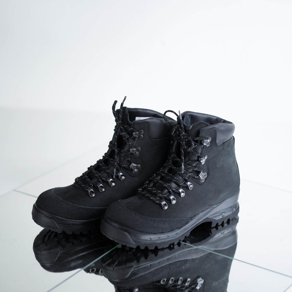 4. Pair of Samelin 553P black hiking boots on reflective surface, emphasizing rugged design and lacing