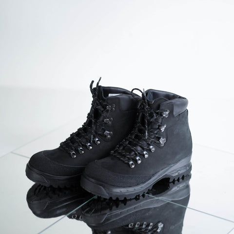 4. Pair of Samelin 553P black hiking boots on reflective surface, emphasizing rugged design and lacing