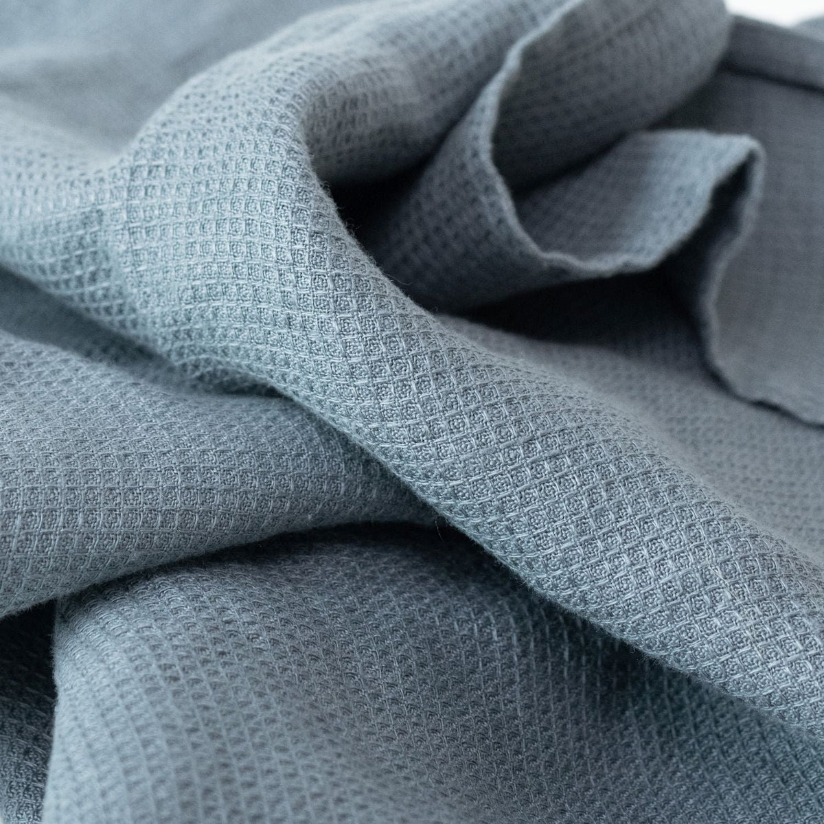 2. Close-up of blue fog waffle linen towel texture showing fine weave detail