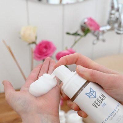 4. Vegan Fox Cleansing Foam being dispensed into hand, 200 ml, in bathroom with flowers